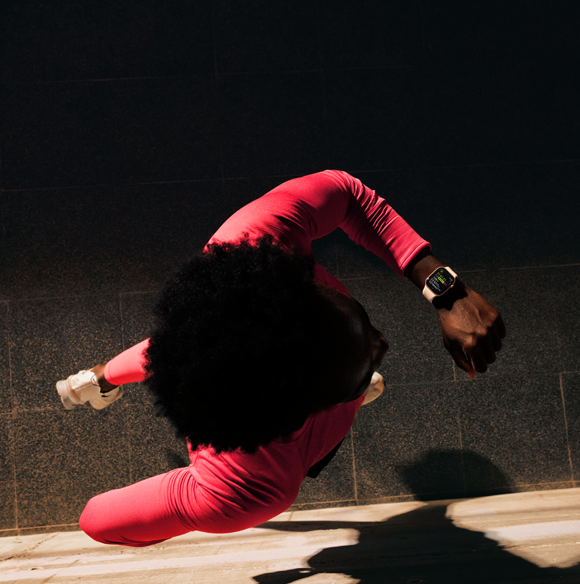 A person checks progress on Apple Watch Series 11 Workout app while running