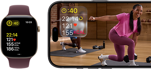 Apple Watch next to iPhone with Apple Fitness+ class on screen