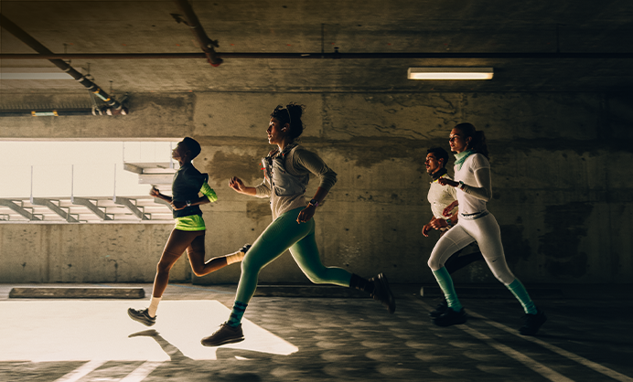 A group of people running in a city while wearing Apple Watch Series 12