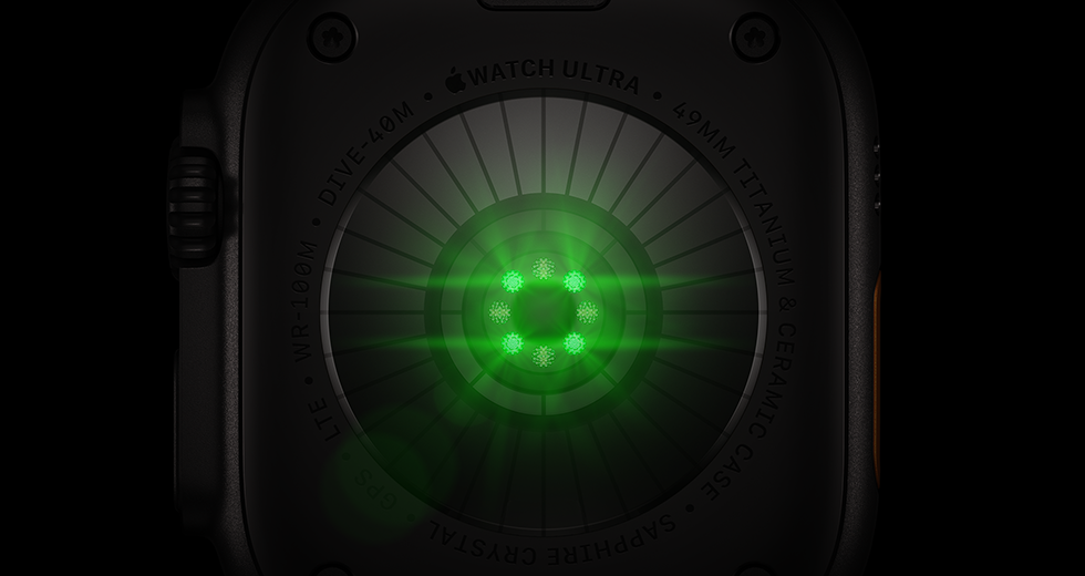 Back of Apple Watch Ultra 4, titanium case, black color, multiple round sensors with glowing green LED lights