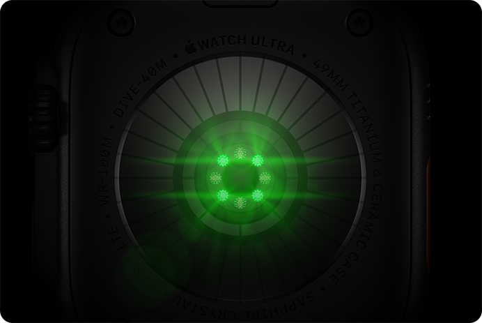 Back of Apple Watch Ultra 4, titanium case, black color, multiple round sensors with glowing green LED lights