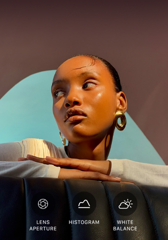 Close up portrait of a well-lit model with a colorful background, demonstrating the pro camera system's Pro controls UI: Lens Aperture, Histogram, White Balance