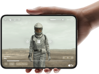 iPhone Duo, held with one hand, opened in horizontal orientation, fully unfolded, interior screen displays Apple TV show "Silo"